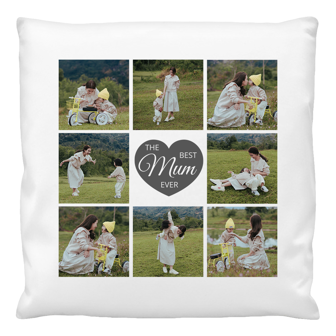 A cushion cover featuring a collage of photos with a central heart shape containing the text 'The Mum Ever'. The photos show a woman with a baby in a field.