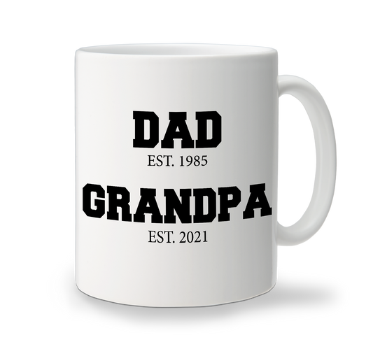 A white custom cofee mug with black text that reads 'DAD EST. 1985' and 'GRANDPA EST. 2021'.
