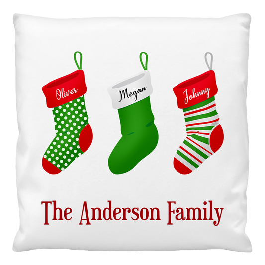 A custom printed cushion cover featuring three Christmas stockings with the names Oliver, Megan, and Johnny, and the text 'The Anderson Family' at the bottom.