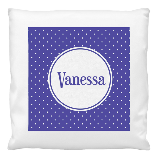 A blue cushion cover with white polka dots and a personalized name 'Vanessa' printed in the center.
