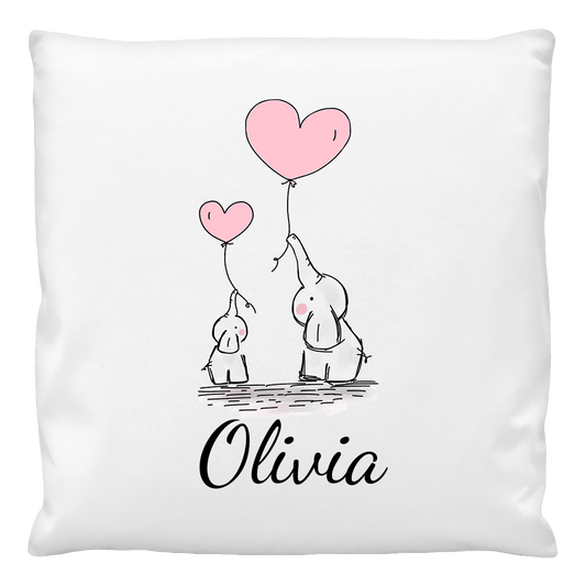 A white cushion cover with a printed design featuring two cartoon elephants holding a pink balloon, with the name 'Olivia' printed at the bottom.