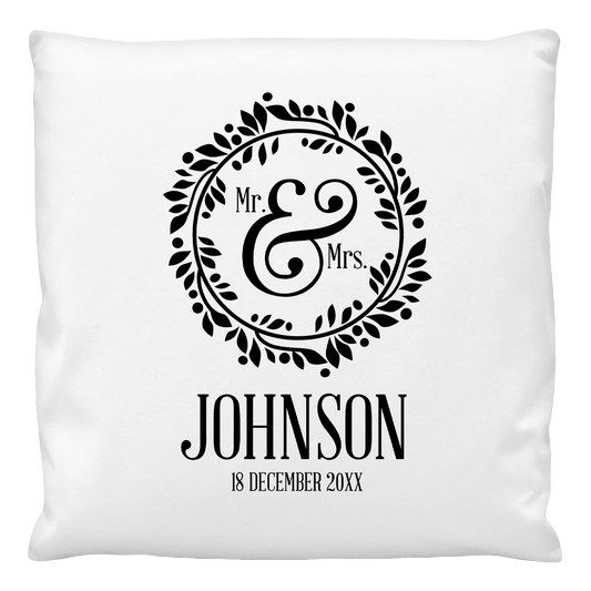 A white cushion cover with a black 'Mr & Mrs' wreath design and personalized text that reads 'JOHNSON 18 December 2019'. The inner cushion is not included.