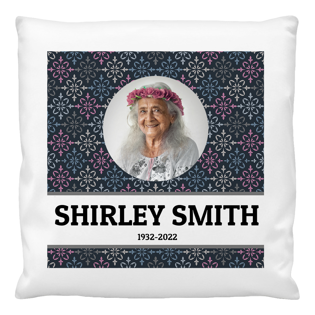 A cushion cover featuring a printed photo of an older woman with a floral pattern in the background. The name 'SHIRLEY SMITH' and the years '1932-2022' are printed on the cushion.